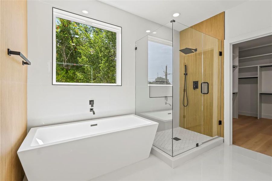 Full bathroom featuring a soaking tub, a stall shower, recessed lighting, a walk in closet, and tile patterned flooring