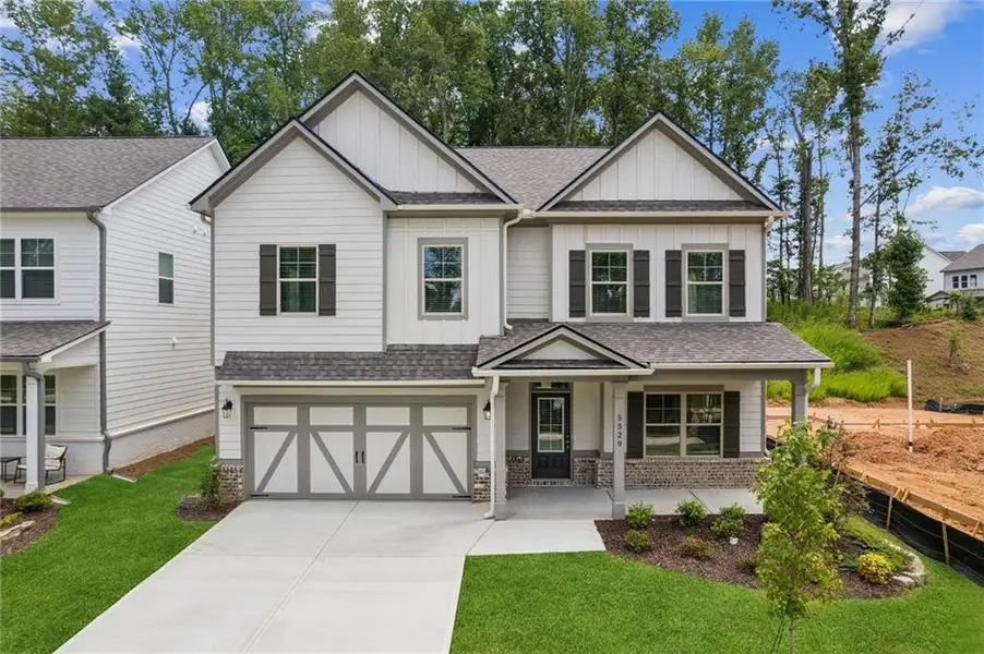 Front exterior of a new home in , Flowery Branch, GA, highlighting curb appeal (Image 1). Front exterior of a new home in , Flowery Branch, GA, highlighting curb appeal (Image 1).