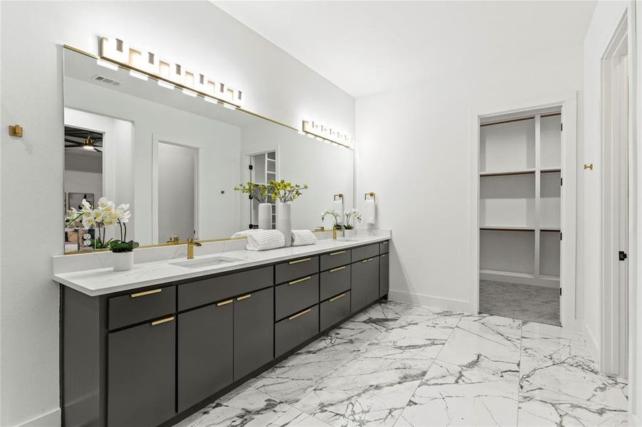 Full bathroom with a sink, visible vents, marble finish floor, a spacious closet, and double vanity