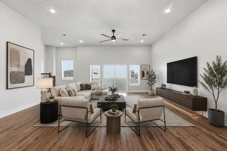 Experience the perfect blend of style and comfort in this virtually staged, spacious living room featuring wide-plank flooring, a sleek seating arrangement, recessed lighting, and a stunning wall of windows that floods the space with natural light. Experience the perfect blend of style and comfort in this virtually staged, spacious living room featuring wide-plank flooring, a sleek seating arrangement, recessed lighting, and a stunning wall of windows that floods the space with natural light.