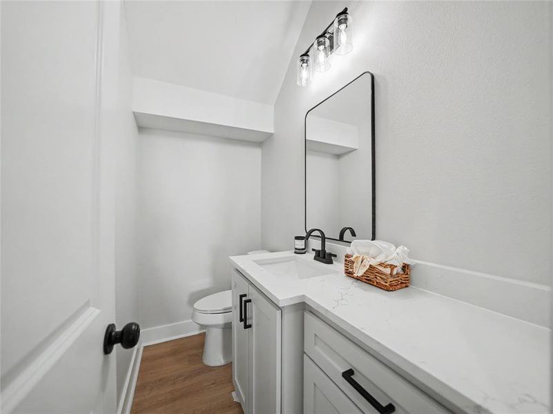 Modern bathroom featuring a single vanity with a white countertop, undermount sink, and matte black faucet Modern bathroom featuring a single vanity with a white countertop, undermount sink, and matte black faucet