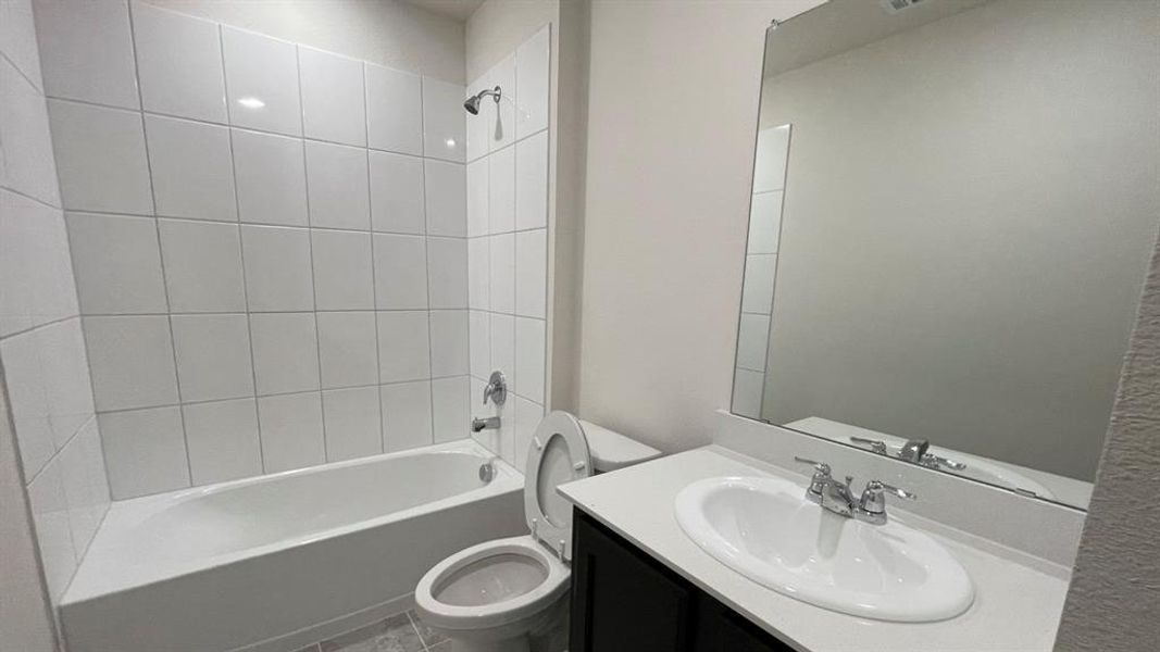 Full bathroom featuring a white porcelain bathtub, chrome shower fixtures, and white subway tile surround