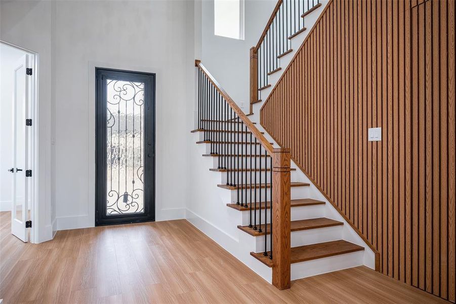 Luxurious entry with Gorgeous lighting and a hidden closet.