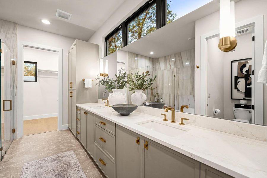 Full bathroom featuring a stall shower, double vanity, a walk in closet, light marble finish flooring, and recessed lighting