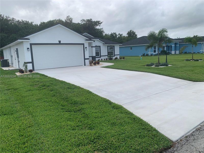 Front exterior of a new home in , Lake Placid, FL, highlighting curb appeal (Image 18).