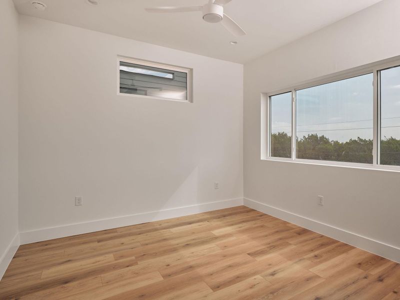 Spare room featuring light wood-style floors, a ceiling fan, and recessed lighting