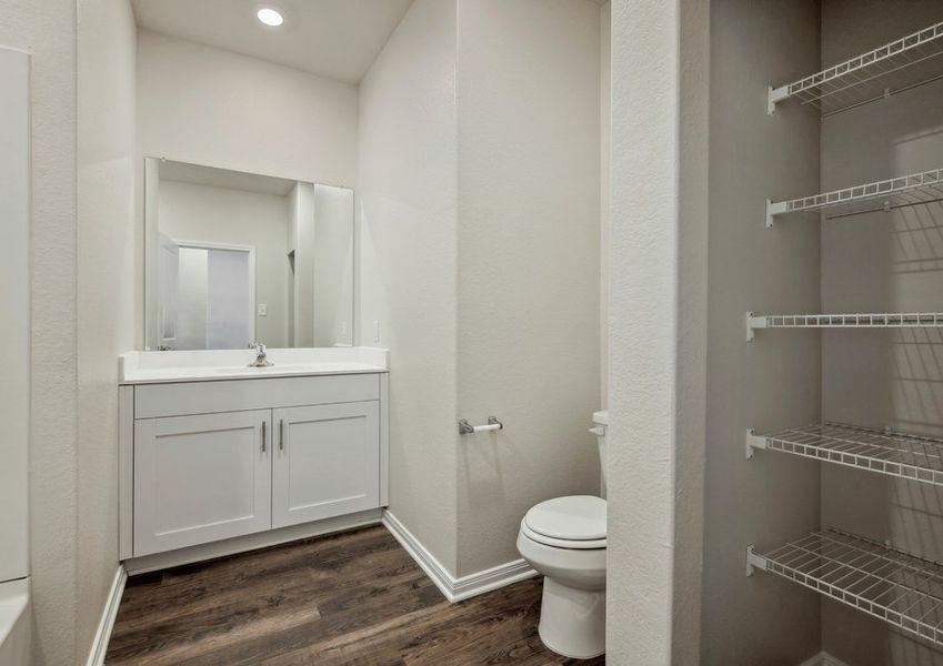 Secondary bathroom with storage shelves