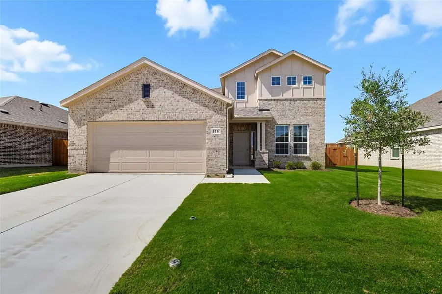 View of front of property featuring brick siding, driveway, a garage, and board and batten siding View of front of property featuring brick siding, driveway, a garage, and board and batten siding