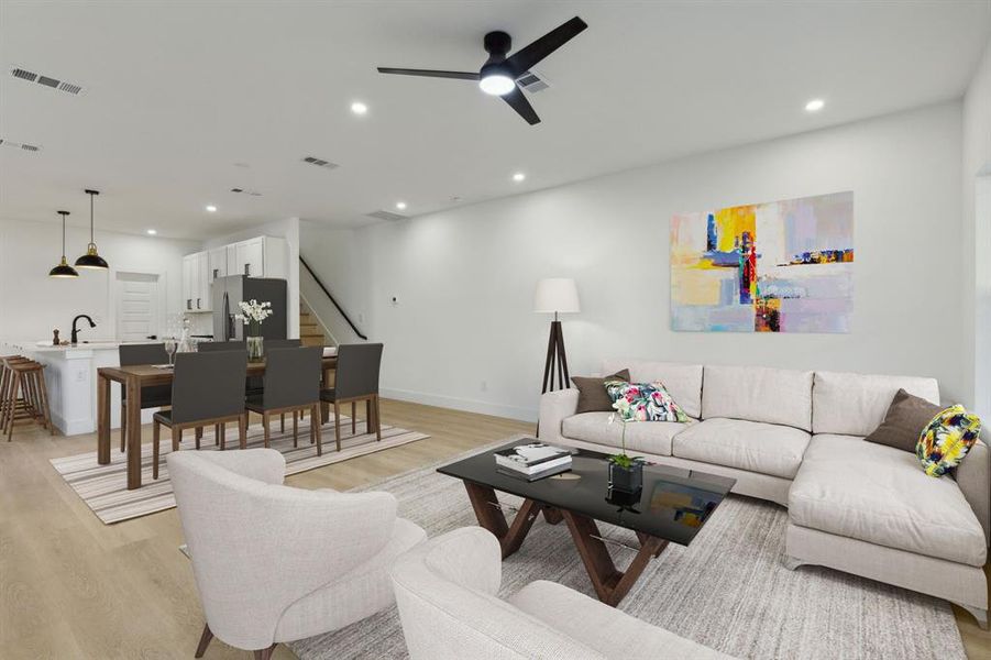 Living room featuring light hardwood / wood-style floors and ceiling fan