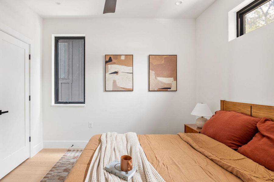 Bedroom with light wood-type flooring, recessed lighting, and a ceiling fan Bedroom with light wood-type flooring, recessed lighting, and a ceiling fan