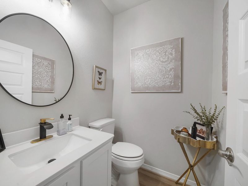 The half bath has been tastefully updated with modern fixtures and clean, refined finishes that complement the home’s overall design.