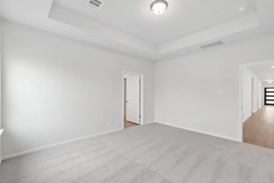 The Oakshire II- Primary Bedroom with Tray Ceiling.  Sample image for illustration; upgrades, options, and colors may vary.