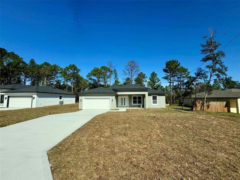 Front exterior of a new home in , Citrus Springs, FL, highlighting curb appeal (Image 12).
