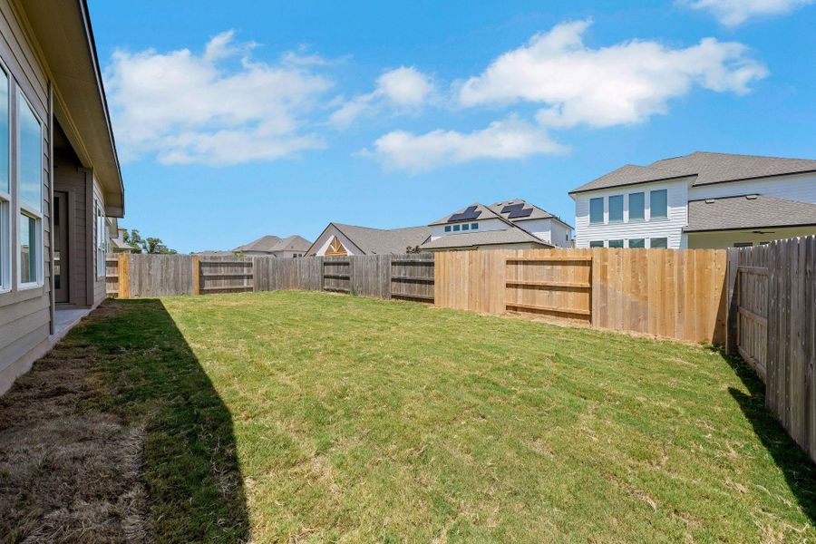 Fenced backyard with a residential view