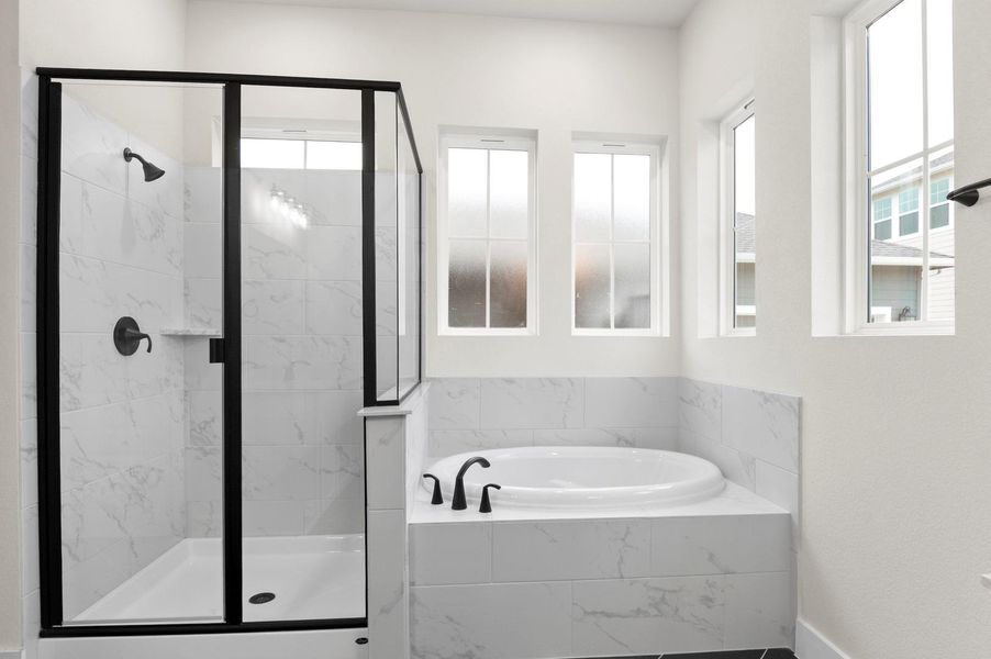 Bathroom with a garden tub and a marble finish shower