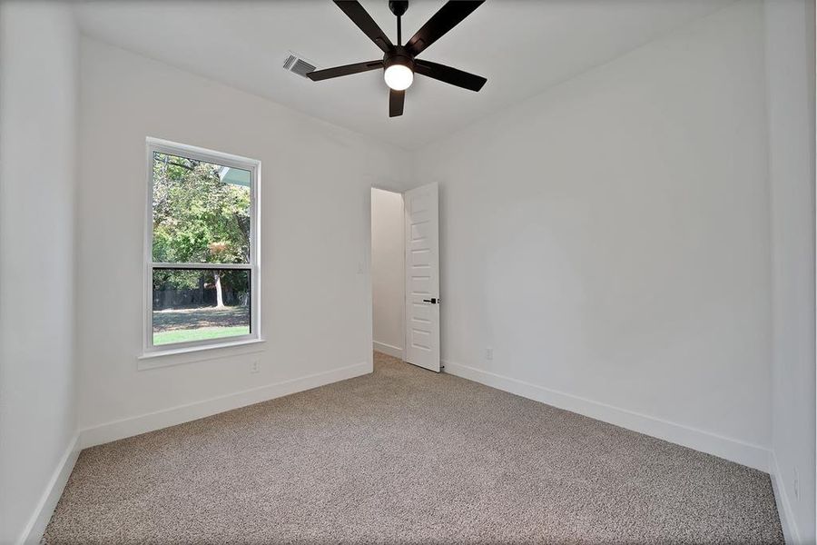 Unfurnished room featuring carpet floors and ceiling fan Unfurnished room featuring carpet floors and ceiling fan