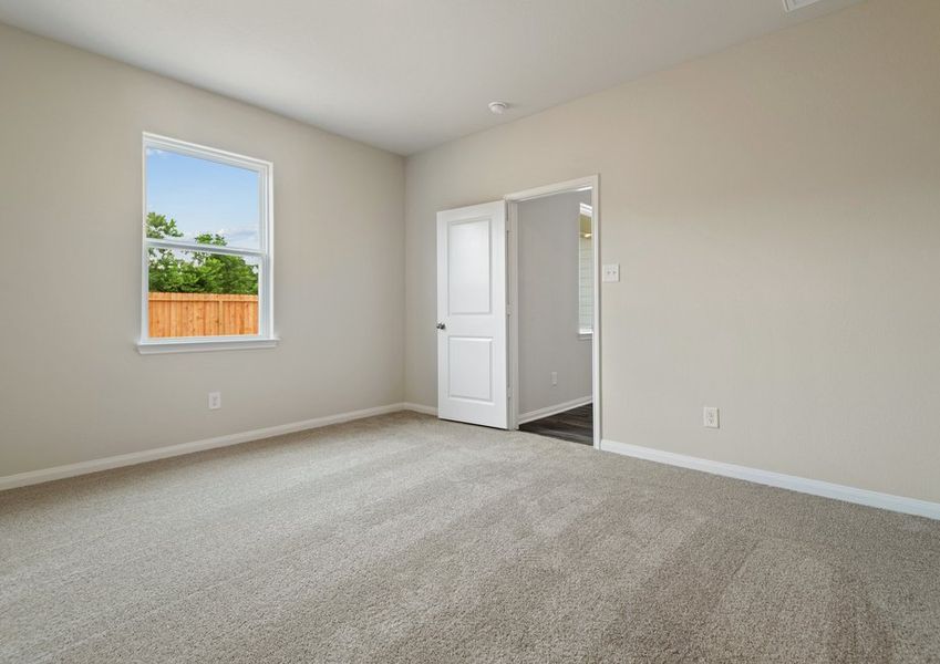 Master bedroom with a large window and ceiling fan light fixture Master bedroom with a large window and ceiling fan light fixture