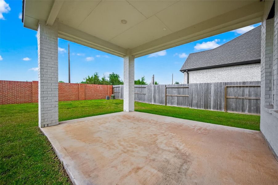 Covered back patio offers the ideal setting for outdoor entertaining, rain or shine.
