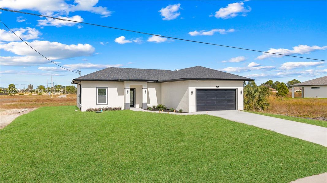 Front exterior of a new home in , Lehigh Acres, FL, highlighting curb appeal (Image 2).