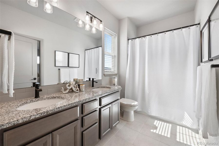 2nd floor full bath with expansive vanity, natural light.