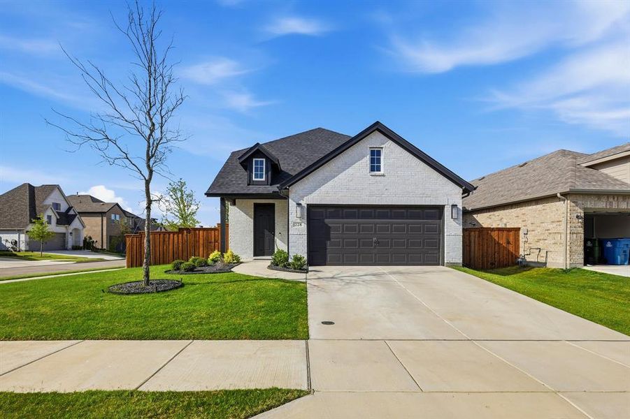 Front exterior of a new home in , Rhome, TX, highlighting curb appeal (Image 21). Front exterior of a new home in , Rhome, TX, highlighting curb appeal (Image 21).