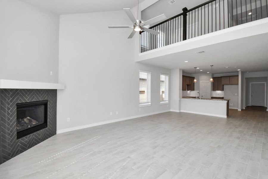 Take another glimpse into the heart of the home with this additional view of the family room—a sprawling space ready to accommodate all your gatherings. Sample photo of completed home with similar floor plan. Actual colors and selections may vary.