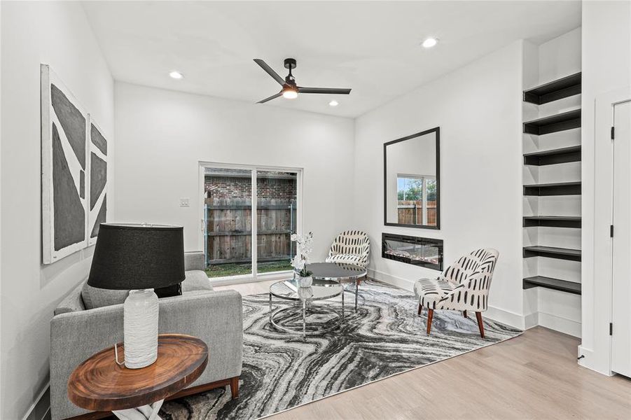 Living room featuring light wood-type flooring and ceiling fan