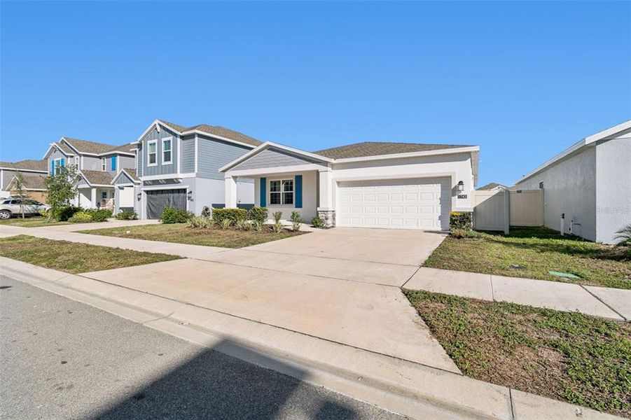Front exterior of a new home in Ranches at Lake McLeod, Eagle Lake, FL, highlighting curb appeal (Image 28).