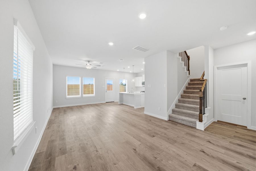 A large empty room with a wood floor and white walls. A large empty room with a wood floor and white walls.