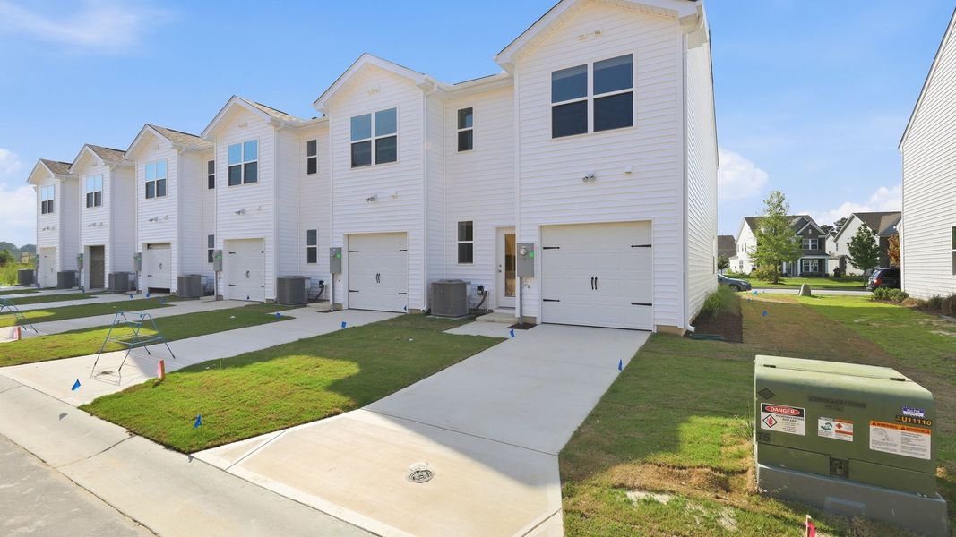 Front exterior of a new home in Clock Road Townhomes, New Bern, NC, highlighting curb appeal (Image 21). Front exterior of a new home in Clock Road Townhomes, New Bern, NC, highlighting curb appeal (Image 21).