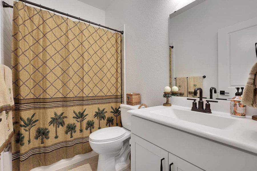 This bathroom features a large mirror with combo shower/bathtub for your guests or family!