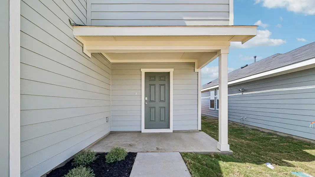 Exterior details and patio area of a home in Prairie Lakes, Buda (Image 3).