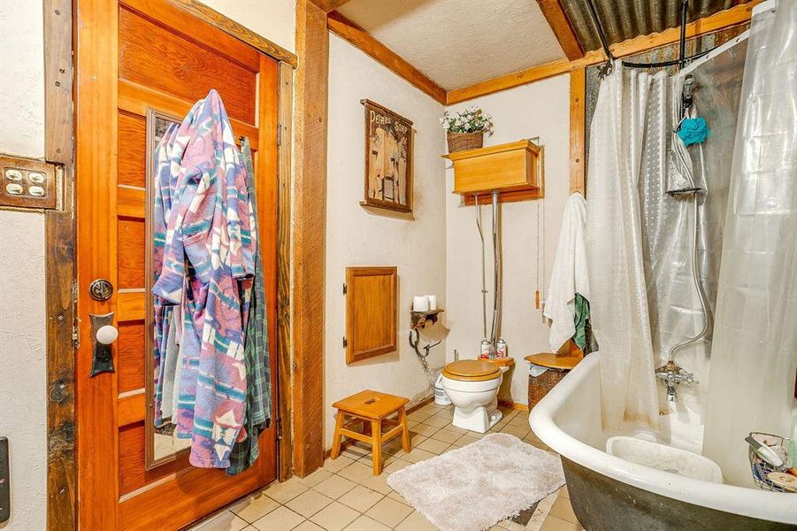 Bathroom with tile patterned floors and a textured ceiling Bathroom with tile patterned floors and a textured ceiling