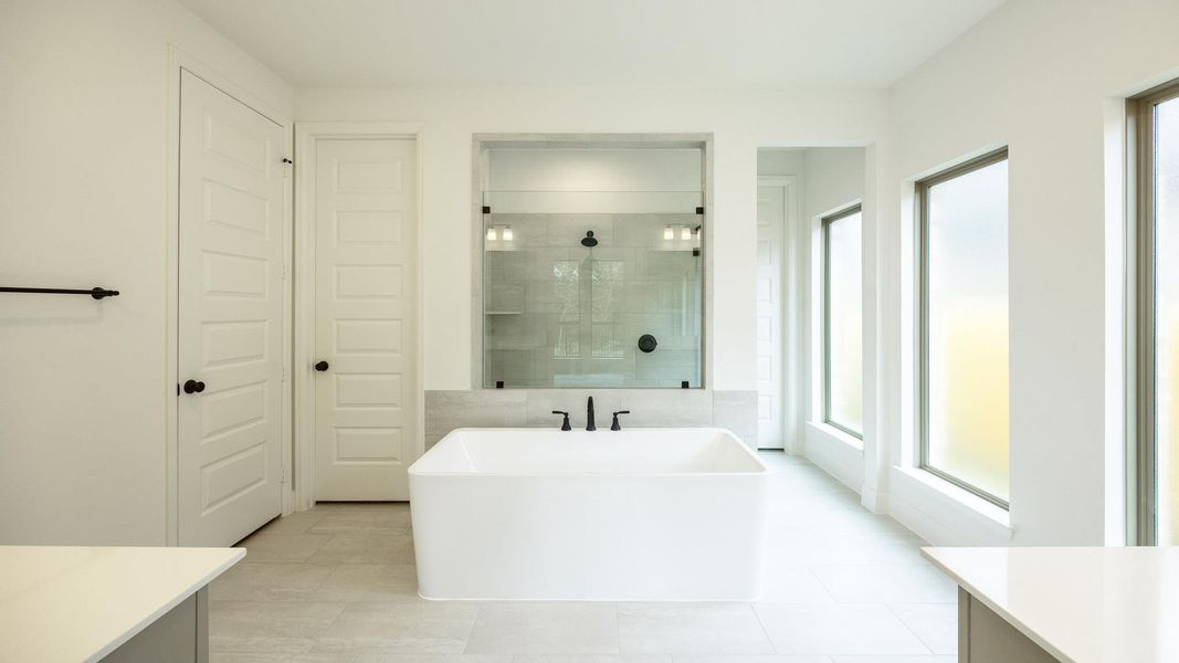 Bathroom with vanity, a walk in shower, a soaking tub, and light tile patterned flooring Bathroom with vanity, a walk in shower, a soaking tub, and light tile patterned flooring