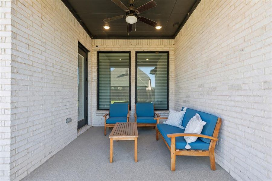 View of patio lounge area and ceiling fan