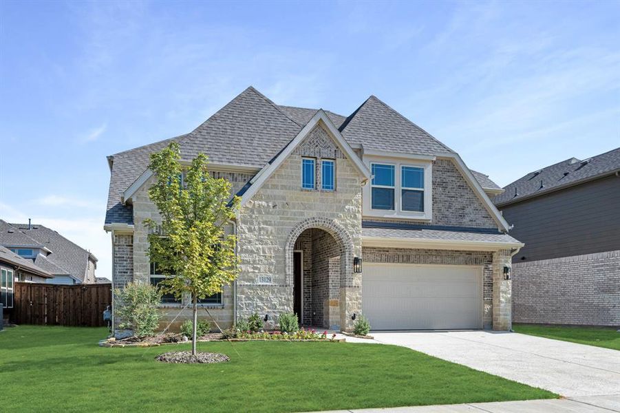 Front exterior of a new home in Woodstone, Providence Village, TX, highlighting curb appeal (Image 1).