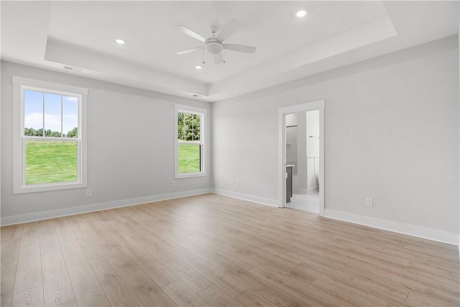 Recessed lighting and a ceiling fan illuminate thi Recessed lighting and a ceiling fan illuminate thi