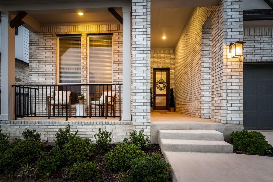 Brick exterior featuring a covered entry porch and a separate covered patio space Brick exterior featuring a covered entry porch and a separate covered patio space