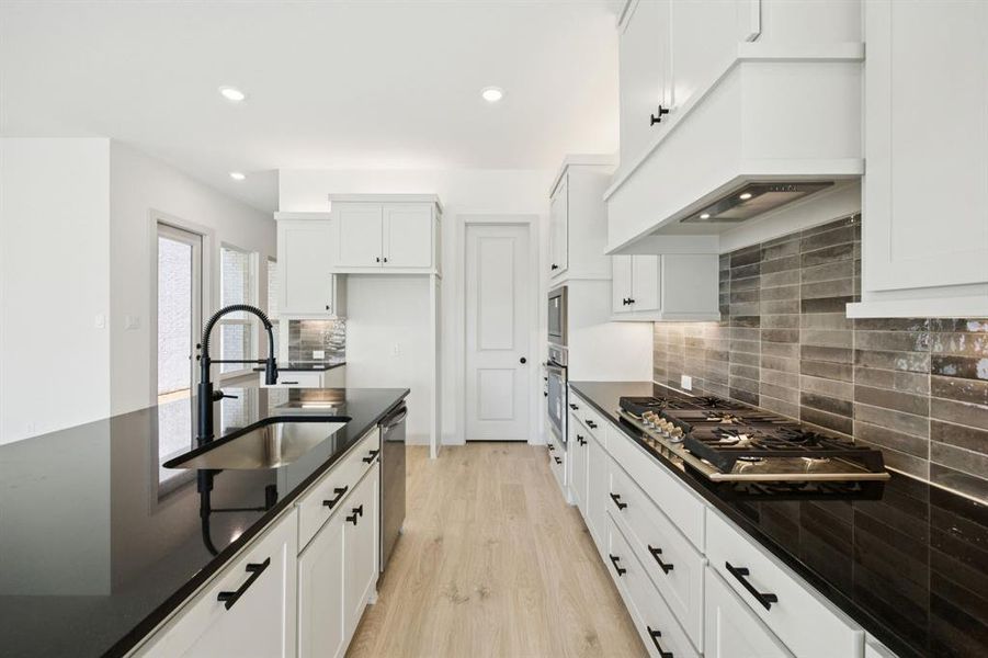 Beautiful cabinetry, striking countertops and designer backsplash paired with contemporary stainless steel effortlessly blend together to create the kitchen of your dreams! Beautiful cabinetry, striking countertops and designer backsplash paired with contemporary stainless steel effortlessly blend together to create the kitchen of your dreams!