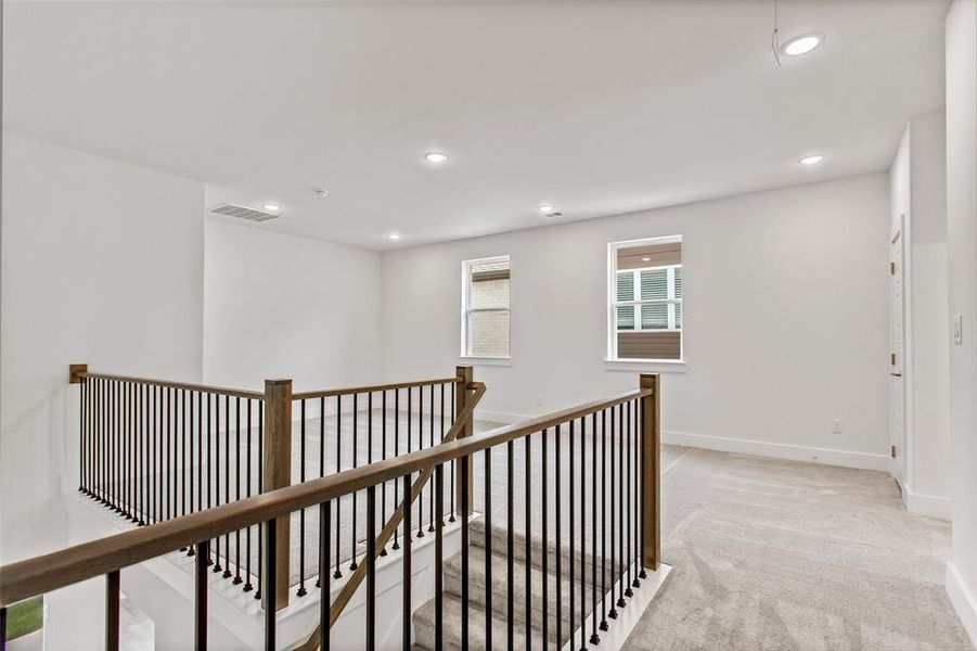 Hallway with light colored carpet