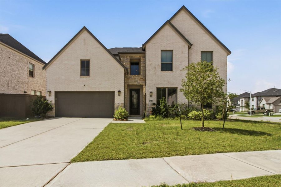 Front exterior of a new home in The Trails, New Caney, TX, highlighting curb appeal (Image 1). Front exterior of a new home in The Trails, New Caney, TX, highlighting curb appeal (Image 1).