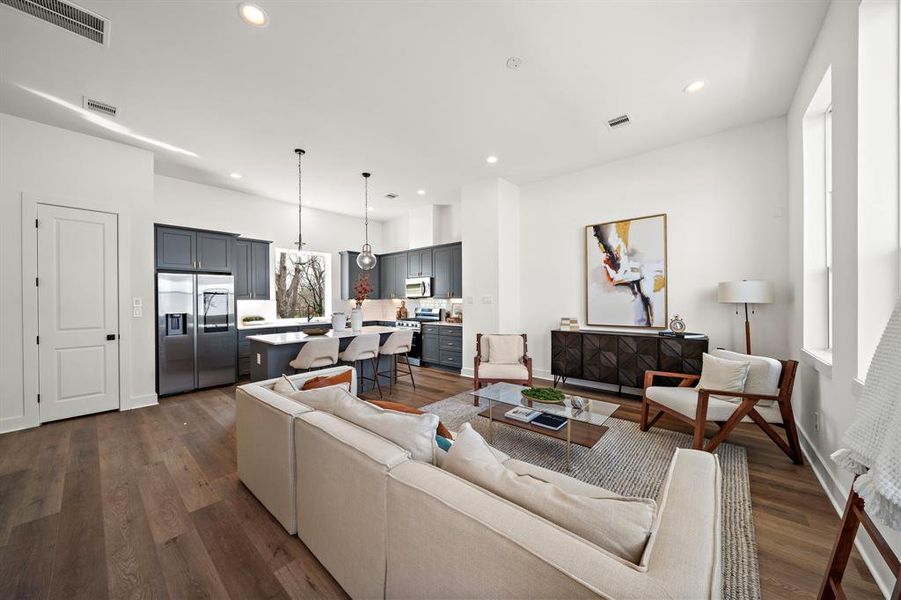 Discover a seamless blend of style and functionality in this inviting open-concept living and kitchen area, perfect for modern living and entertaining.