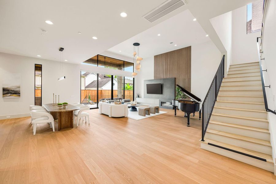 [OPEN LIVING] Spectacular living spaces unfold beneath soaring ceilings, where a dramatic wall of glass doors invites an abundance of natural light and creates a breathtaking indoor-outdoor living experience.