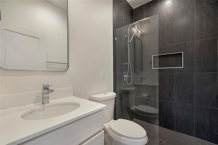 Full bathroom featuring walk in shower and vanity Full bathroom featuring walk in shower and vanity