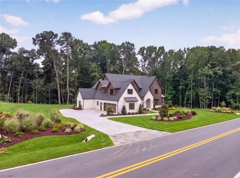 Front exterior of a new home in , Loganville, GA, highlighting curb appeal (Image 4). Front exterior of a new home in , Loganville, GA, highlighting curb appeal (Image 4).