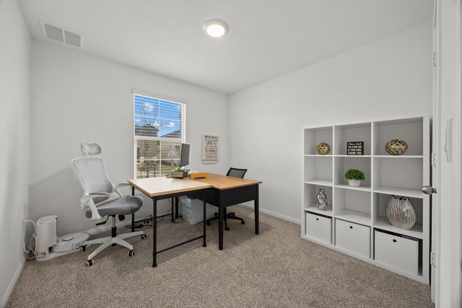 Home office with light carpet and baseboards