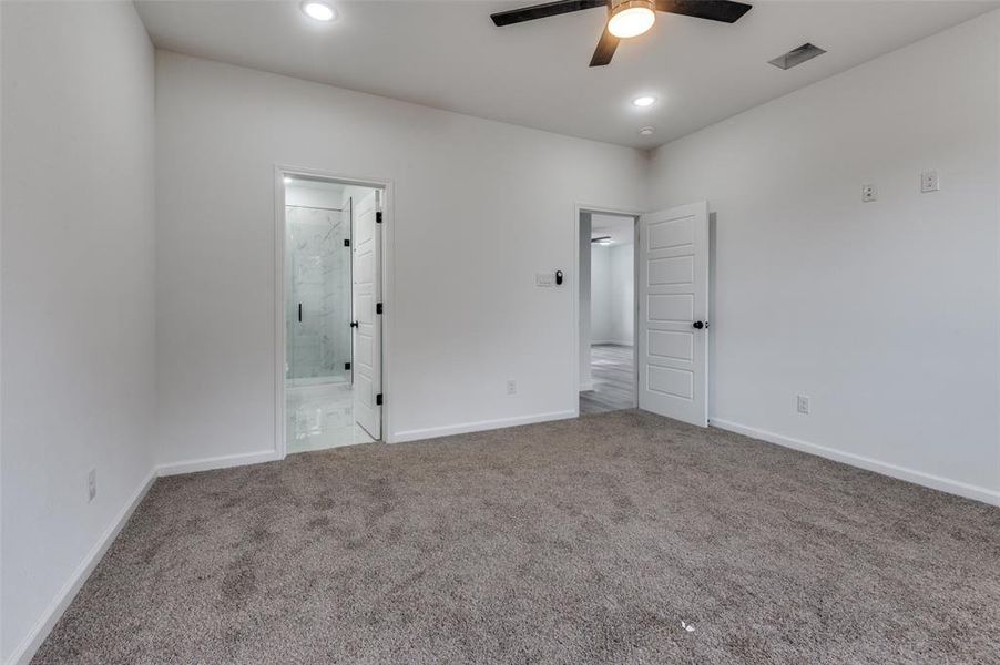 Empty room with carpet and ceiling fan