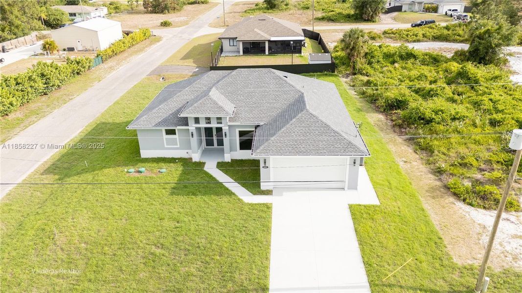 Front exterior of a new home in , Lehigh Acres, FL, highlighting curb appeal (Image 22).
