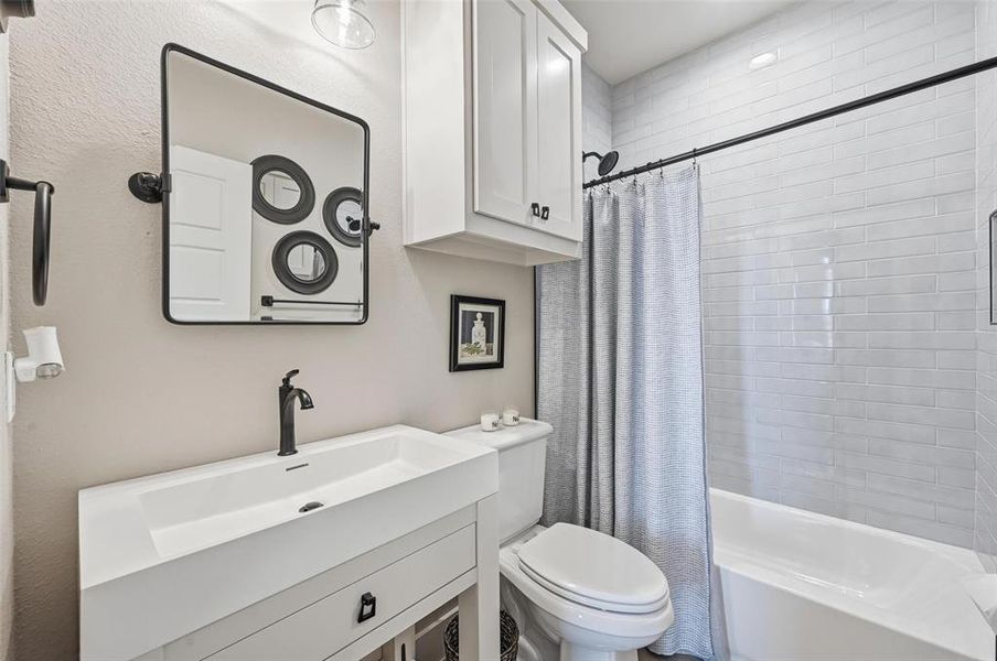 Bathroom with shower / tub combo with curtain and vanity Bathroom with shower / tub combo with curtain and vanity