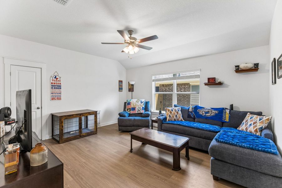 Open concept living area featuring wood-finish flooring, a ceiling fan, and recessed lighting